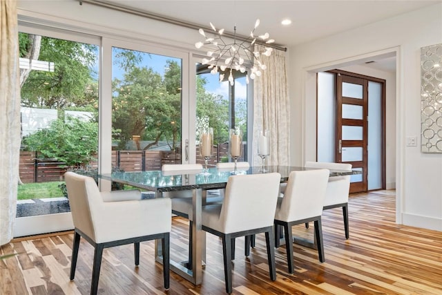 2902 Cedarview Dr, Austin, TX 78704 - dining room with baseboards, a notable chandelier, wood finished floors, and a wealth of natural light