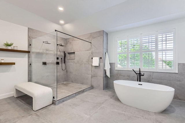full bath with a freestanding bath, a shower stall, and recessed lighting