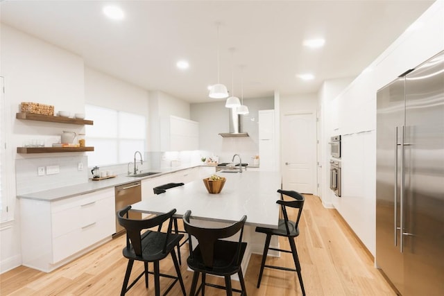 kitchen featuring a sink, modern cabinets, open shelves, and stainless steel appliances