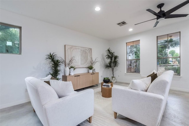 living area with recessed lighting, baseboards, visible vents, and ceiling fan