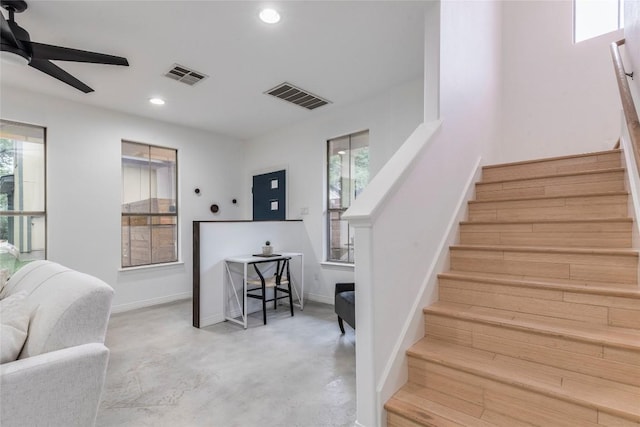 stairway featuring ceiling fan, concrete flooring, recessed lighting, and visible vents