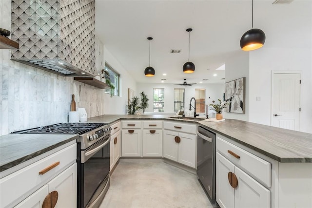 kitchen with tasteful backsplash, open shelves, a sink, stainless steel appliances, and wall chimney exhaust hood