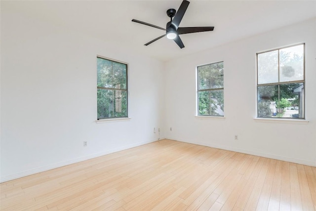 1606 Morgan Ln Unit B, Austin, TX 78704 - unfurnished room with plenty of natural light, hardwood / wood-style floors, a ceiling fan, and baseboards