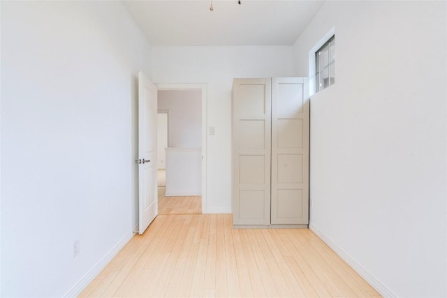 unfurnished bedroom featuring baseboards and light wood finished floors