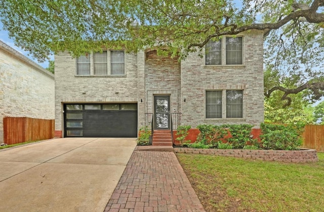 view of front of property featuring an attached garage, a front lawn, fence, and driveway