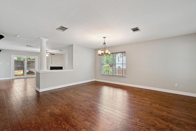 spare room featuring visible vents, a wealth of natural light, and dark wood finished floors
