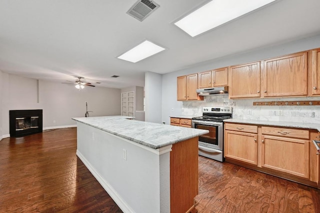 kitchen with visible vents, a center island, under cabinet range hood, backsplash, and stainless steel electric range oven
