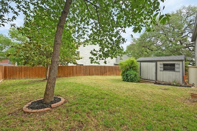 view of yard featuring an outdoor structure, a fenced backyard, and a storage unit