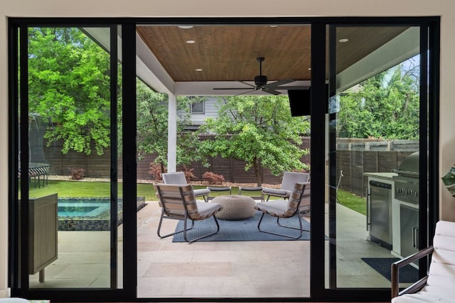 doorway featuring wooden ceiling, a ceiling fan, recessed lighting, and a wealth of natural light