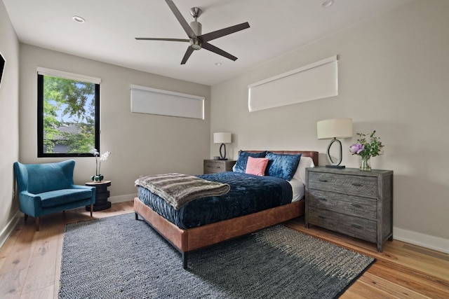 bedroom with baseboards, a ceiling fan, wood finished floors, and recessed lighting