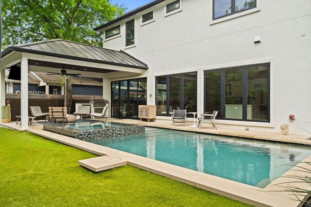 outdoor pool with ceiling fan, a lawn, a patio, a gazebo, and an in ground hot tub