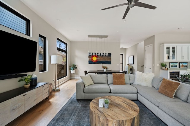 living room featuring ceiling fan and dark wood finished floors