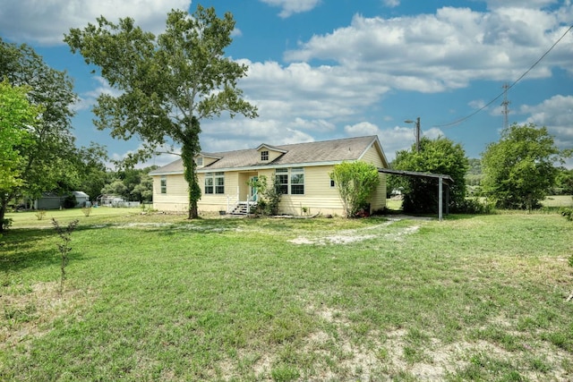 view of front of property with a front yard and an attached carport