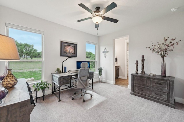 office featuring baseboards, ceiling fan, and carpet
