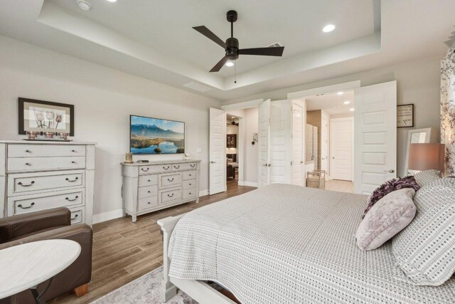 300 Red Mulberry Way, Leander, TX 78641 - bedroom featuring a raised ceiling, wood finished floors, recessed lighting, and ceiling fan