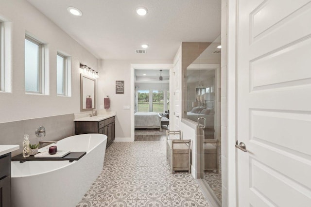 ensuite bathroom featuring ensuite bath, a stall shower, visible vents, and vanity