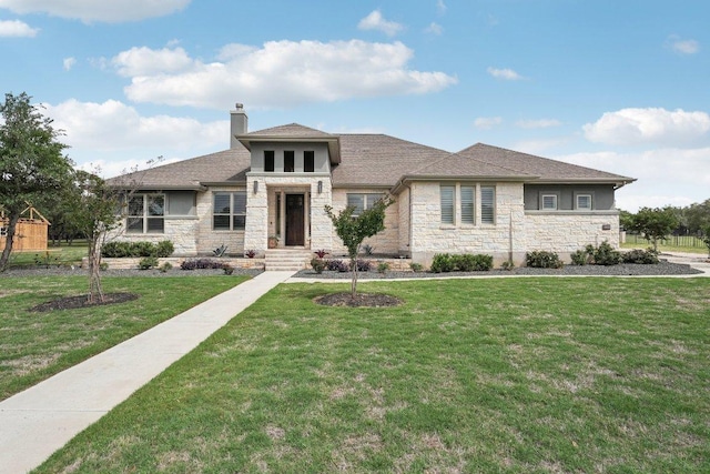 300 Red Mulberry Way, Leander, TX 78641 - prairie-style house with stone siding, a chimney, a front lawn, and roof with shingles