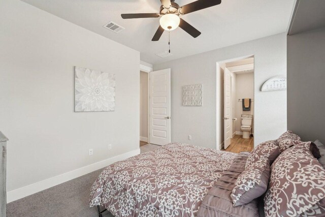 bedroom featuring visible vents, baseboards, ensuite bathroom, and ceiling fan