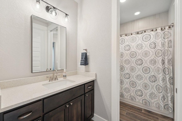 bathroom with vanity, wood finished floors, and a shower with curtain