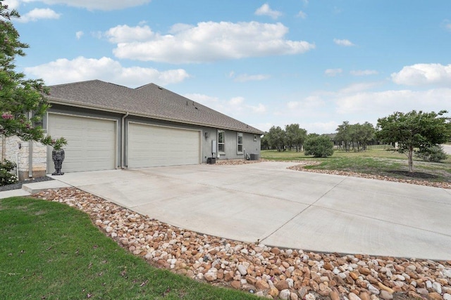 300 Red Mulberry Way, Leander, TX 78641 - view of front of property featuring concrete driveway, a garage, stucco siding, roof with shingles, and a front yard