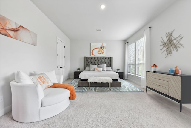 carpeted bedroom with baseboards and visible vents