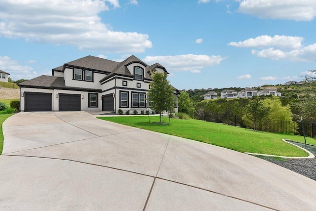 view of front of property featuring stucco siding, fence, a front yard, and concrete driveway