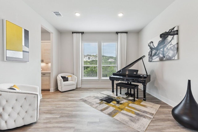 sitting room featuring recessed lighting, baseboards, and wood finished floors