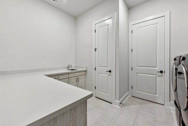4617 Port Genova Ct, Leander, TX 78641 - laundry area with washing machine and dryer, cabinet space, and light marble finish flooring