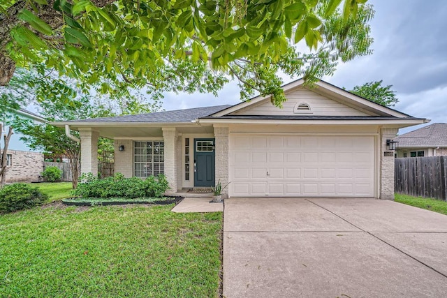 ranch-style home with a garage, a front lawn, fence, brick siding, and driveway