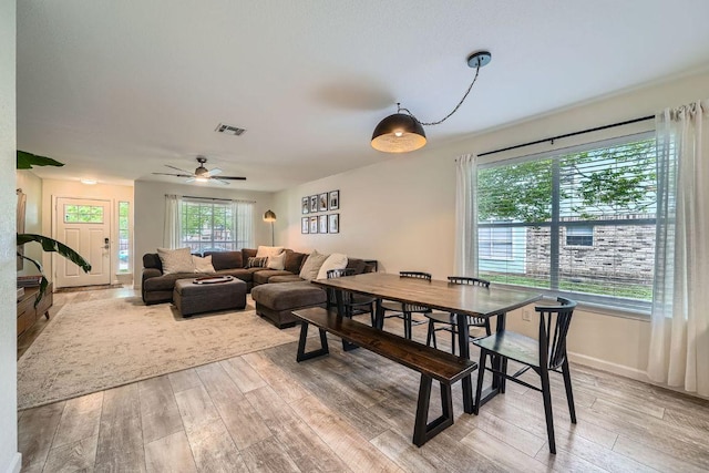 dining room with visible vents, a wealth of natural light, and wood finished floors