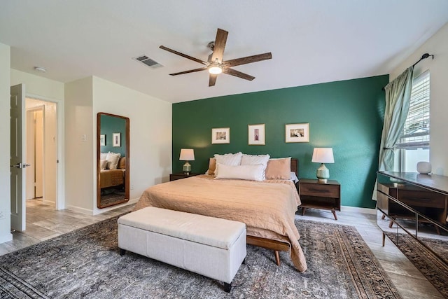 bedroom featuring visible vents, a ceiling fan, and baseboards
