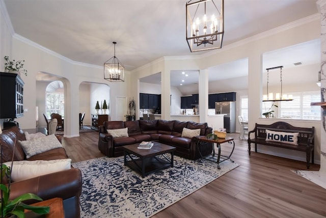 1312 Becca Teal Pl, Round Rock, TX 78681 - living area featuring a chandelier, healthy amount of natural light, wood finished floors, and ornamental molding