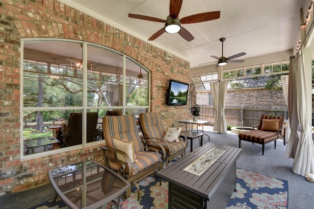 1312 Becca Teal Pl, Round Rock, TX 78681 - sunroom with ceiling fan, an outdoor living space with a fire pit, and healthy amount of natural light