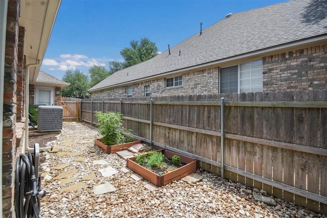 1312 Becca Teal Pl, Round Rock, TX 78681 - fenced backyard featuring a garden and central AC unit