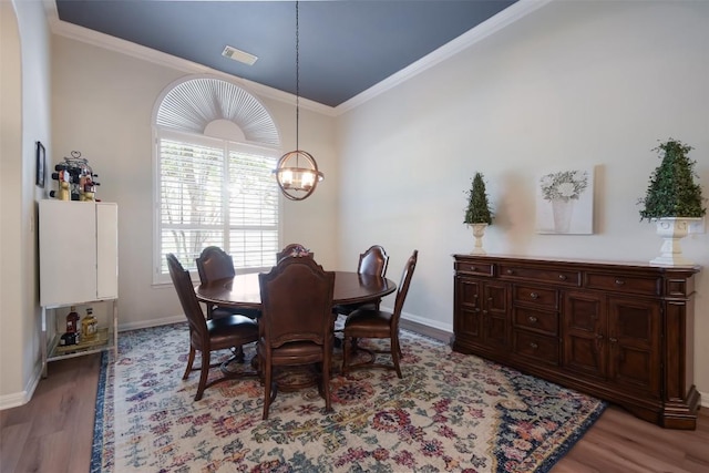1312 Becca Teal Pl, Round Rock, TX 78681 - dining area with light wood-style floors, ornamental molding, a chandelier, and baseboards