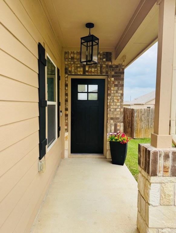 1045 Gaelic Dr, Georgetown, TX 78626 - property entrance featuring a porch and stone siding