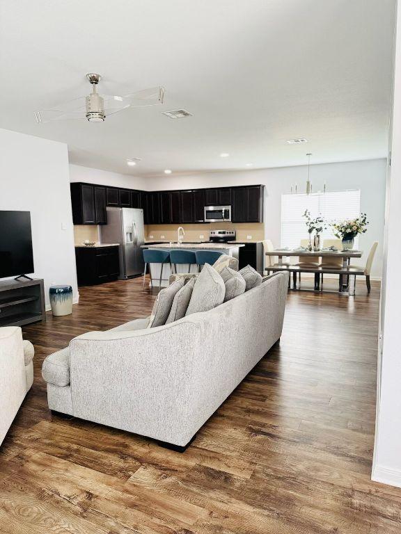 1045 Gaelic Dr, Georgetown, TX 78626 - living area featuring dark wood-style floors and recessed lighting
