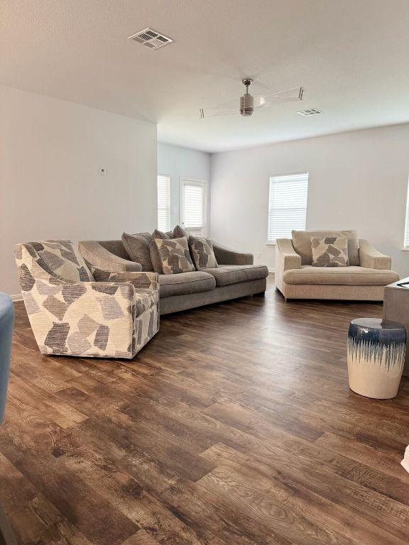 living room with visible vents and wood finished floors