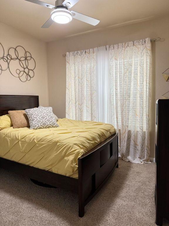 carpeted bedroom featuring a ceiling fan