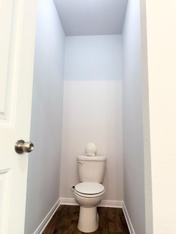 bathroom with baseboards and toilet