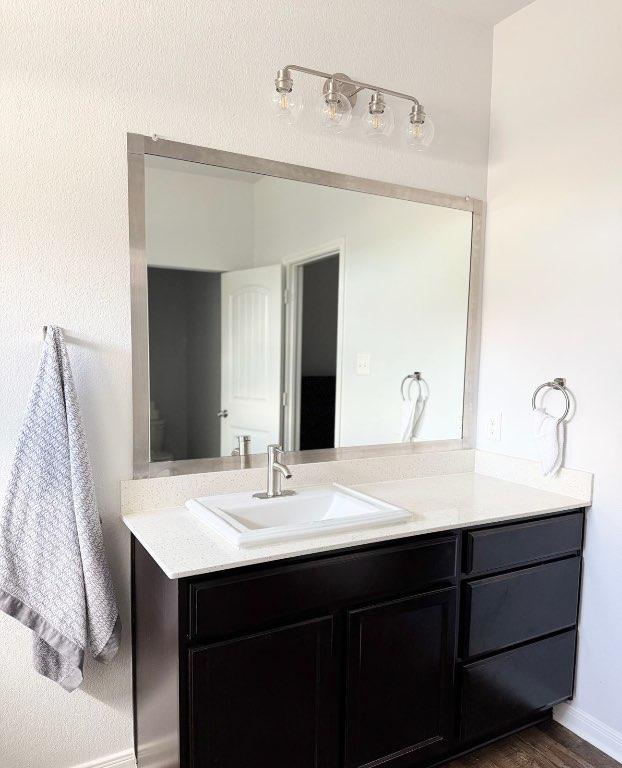 1045 Gaelic Dr, Georgetown, TX 78626 - bathroom featuring vanity and wood finished floors