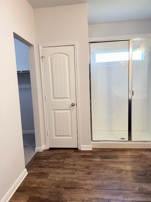 1045 Gaelic Dr, Georgetown, TX 78626 - unfurnished bedroom featuring dark wood-style flooring and baseboards