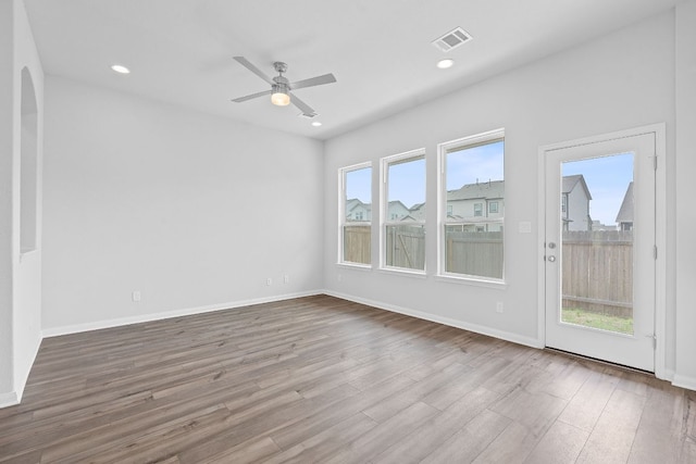 unfurnished room with visible vents, wood finished floors, baseboards, ceiling fan, and recessed lighting