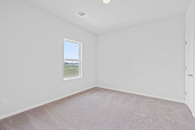 unfurnished room featuring carpet floors, baseboards, and visible vents