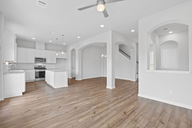 unfurnished living room featuring ceiling fan, recessed lighting, and visible vents