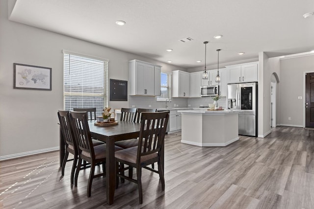 dining room featuring recessed lighting, visible vents, and light wood-style flooring