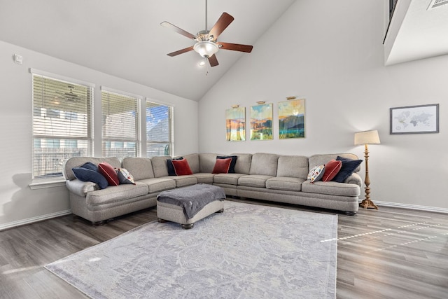 living room with baseboards, a ceiling fan, high vaulted ceiling, and wood finished floors