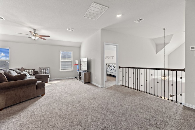 carpeted living room featuring a ceiling fan, visible vents, and a healthy amount of sunlight