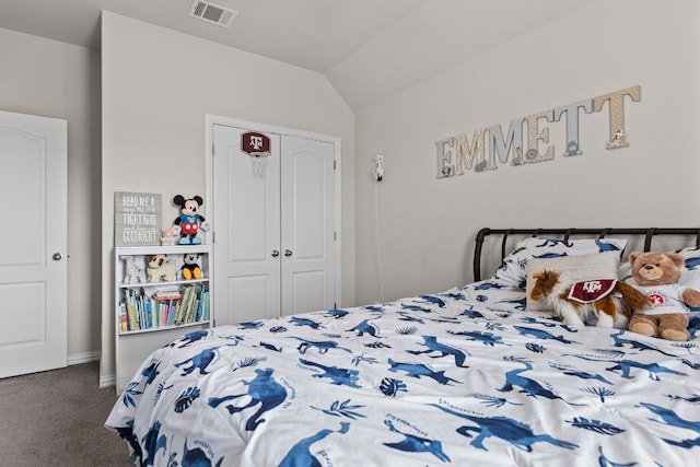 carpeted bedroom with baseboards, visible vents, lofted ceiling, and a closet