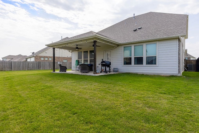 back of house with a lawn, a fenced backyard, ceiling fan, and a patio area